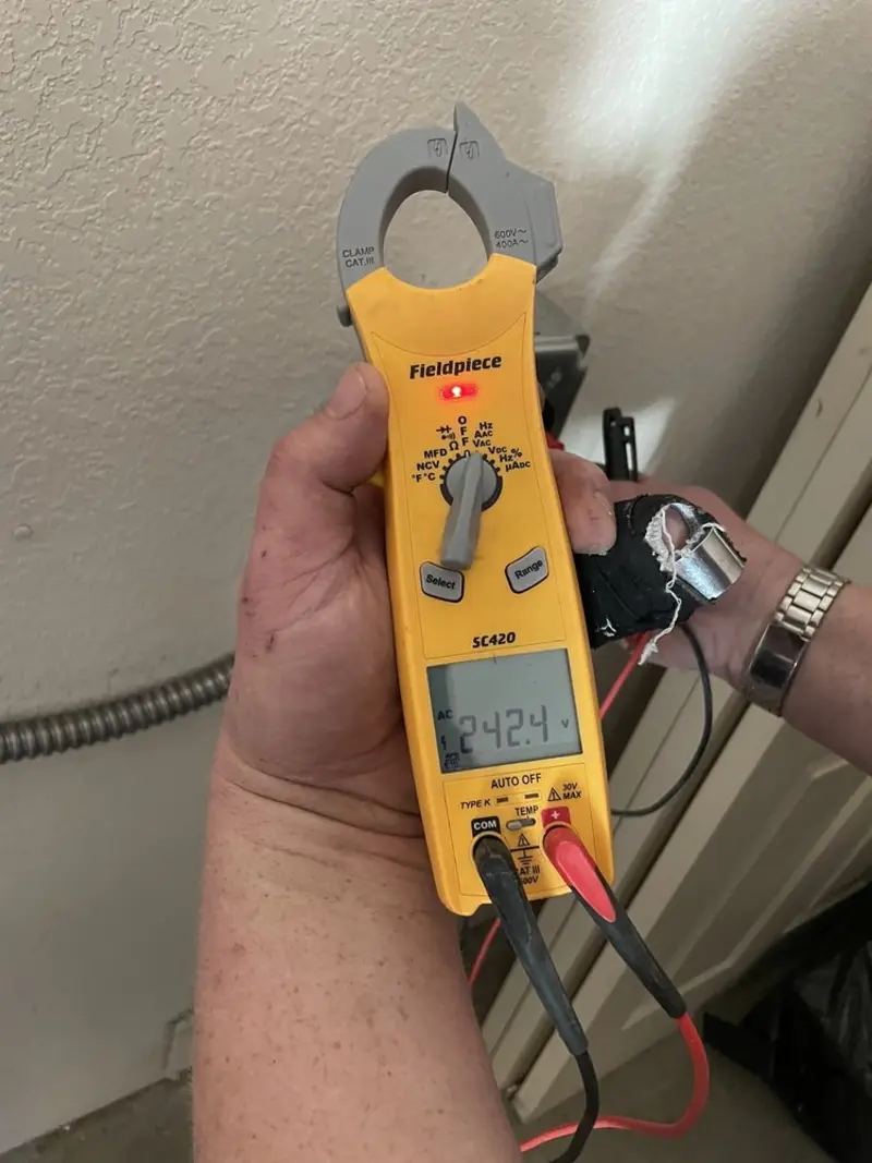 Voltage testing with clamp meter during Generator Installation in Timberwood Park